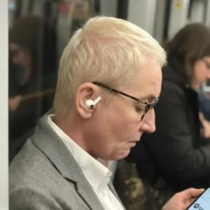 Bad fitting apple airpod earbuds on a persons head